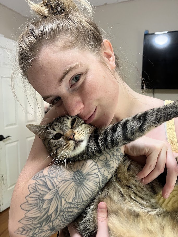 Alyssa snuggling a cat